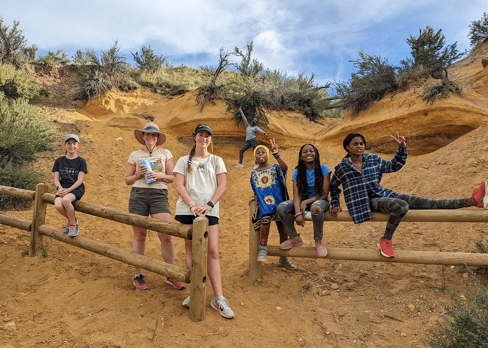 Group of Wild Hearts Idaho participants standing together in a vast desert landscape