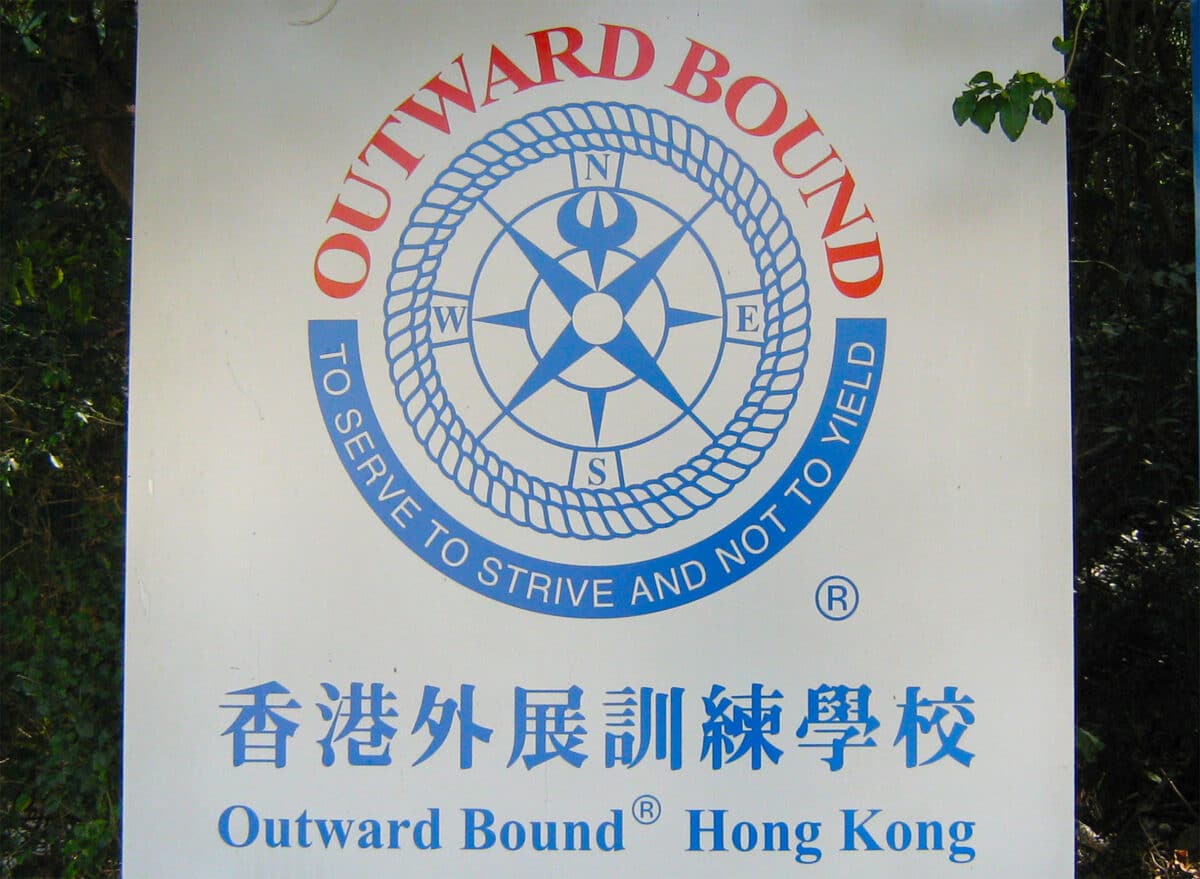 An outward bound sign in Hong Kong, featuring a bold logo 